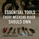 variety of tools laid out on the ground in front of a motorcycle